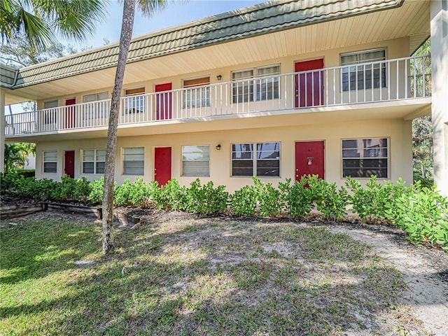 view of front of house featuring a tiled roof and stucco siding