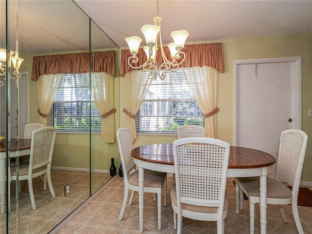 dining area featuring a chandelier and a textured ceiling