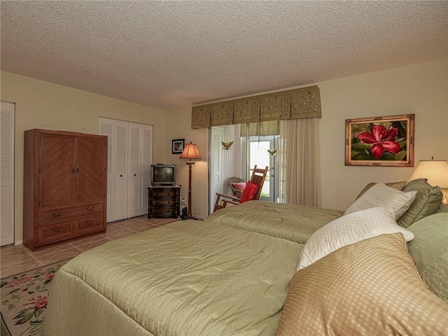 tiled bedroom featuring a textured ceiling