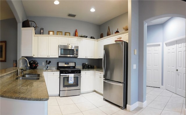 kitchen with white cabinetry, stainless steel appliances, sink, and light tile patterned floors