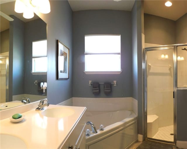 bathroom featuring independent shower and bath, tile patterned flooring, and vanity