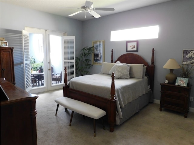 carpeted bedroom featuring access to outside, multiple windows, and ceiling fan