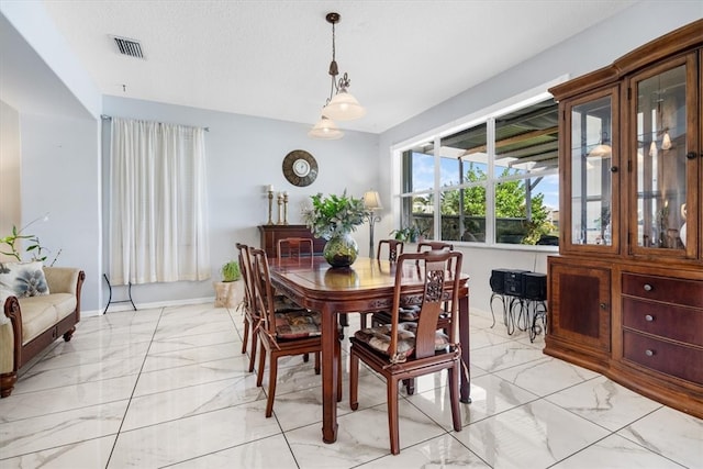 dining area featuring a textured ceiling