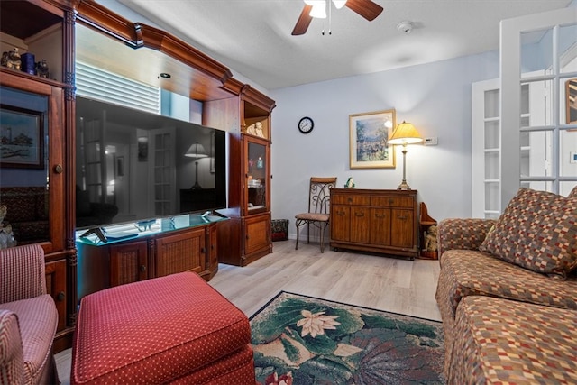 living room featuring light wood-type flooring and ceiling fan