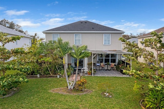 back of house featuring a patio area and a yard