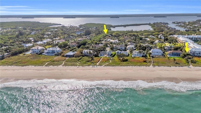 birds eye view of property with a residential view, a water view, and a beach view