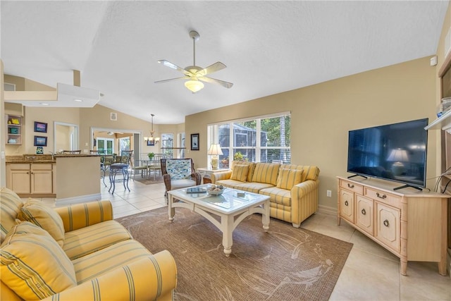 living room featuring lofted ceiling, plenty of natural light, and light tile patterned floors