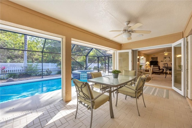 sunroom / solarium featuring ceiling fan and a wealth of natural light