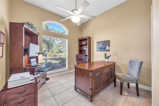 office with light tile patterned flooring, ceiling fan, and baseboards