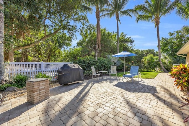 view of patio with fence and area for grilling