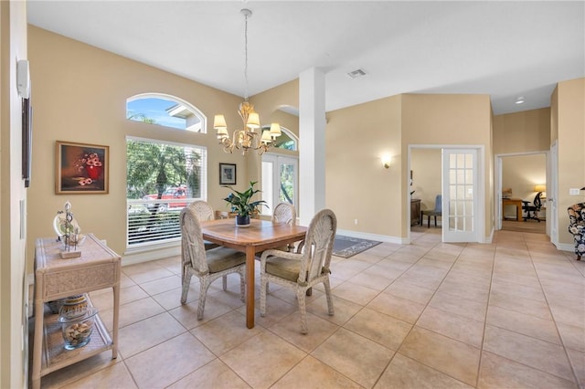 dining area with french doors, light tile patterned floors, visible vents, a chandelier, and baseboards