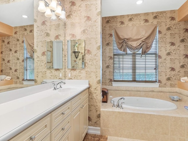 bathroom with a relaxing tiled tub and vanity