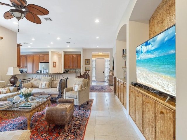 living room with light tile patterned floors and ceiling fan