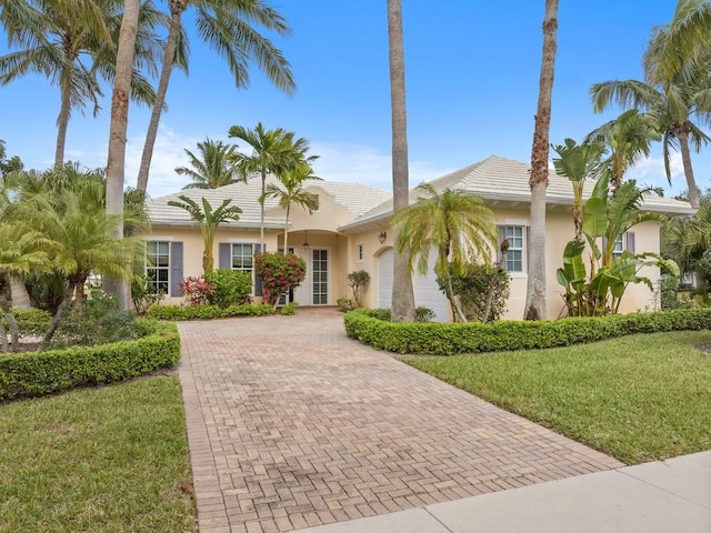 view of front of property featuring a garage and a front yard