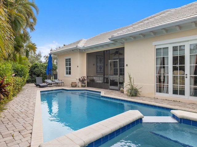 view of pool featuring a patio, ceiling fan, and french doors