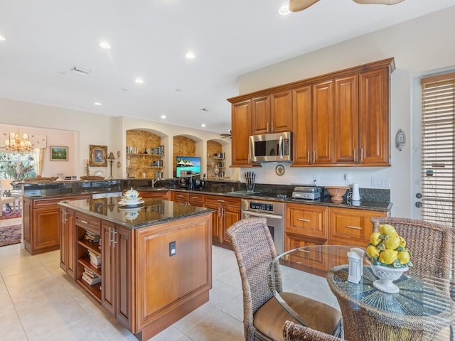 kitchen featuring a healthy amount of sunlight, a center island, stainless steel appliances, and kitchen peninsula