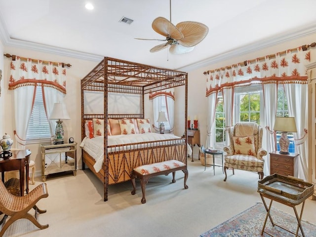 carpeted bedroom featuring ornamental molding and ceiling fan