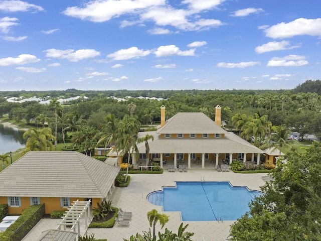 view of swimming pool with a water view and a patio area