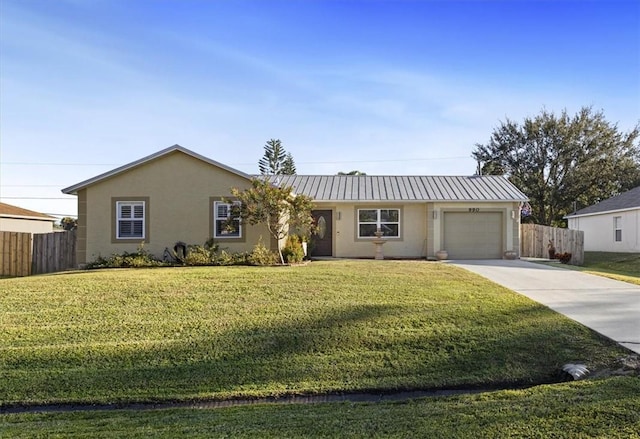 single story home featuring a front yard and a garage