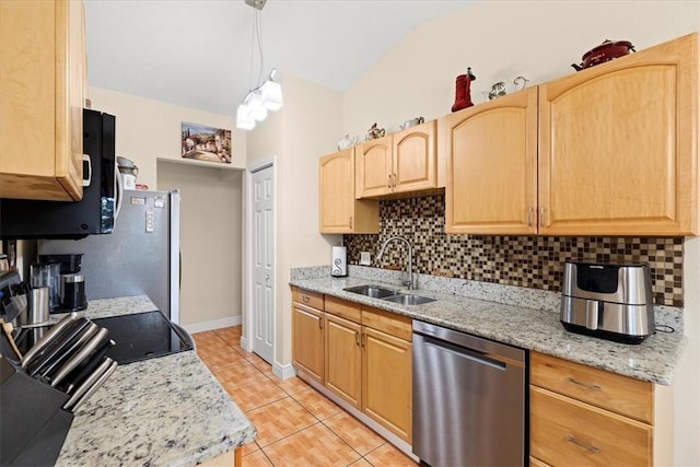 kitchen with sink, light brown cabinets, light stone counters, backsplash, and appliances with stainless steel finishes