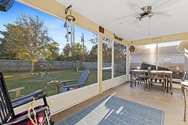 sunroom / solarium featuring ceiling fan