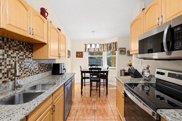 kitchen featuring light brown cabinetry, sink, light tile patterned floors, and stainless steel appliances