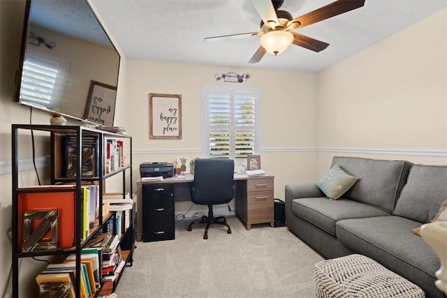 carpeted office with ceiling fan and a textured ceiling