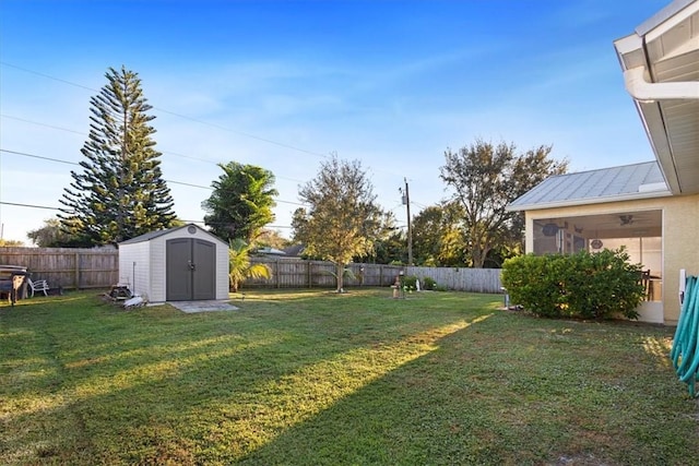 view of yard featuring a storage shed and a sunroom