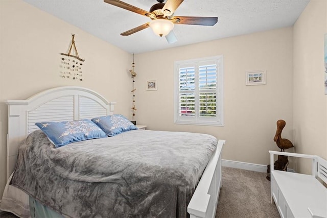 bedroom with carpet, ceiling fan, and a textured ceiling