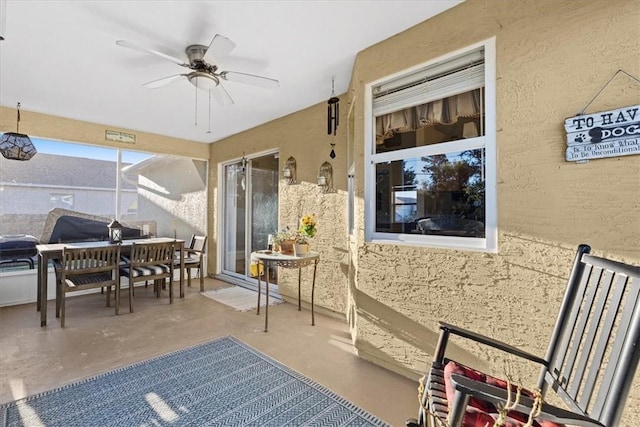 sunroom featuring ceiling fan