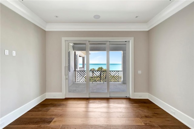 330 N Blue Wave Ln, Vero Beach, FL 32963 - doorway to outside featuring ornamental molding, baseboards, and wood finished floors