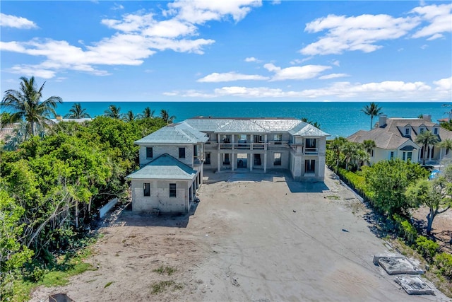 view of front of house featuring a balcony and a water view