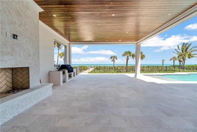 330 N Blue Wave Ln, Vero Beach, FL 32963 - view of patio featuring exterior kitchen, an outdoor pool, and grilling area