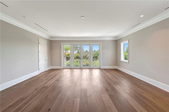 330 N Blue Wave Ln, Vero Beach, FL 32963 - spare room with crown molding, wood finished floors, baseboards, and recessed lighting