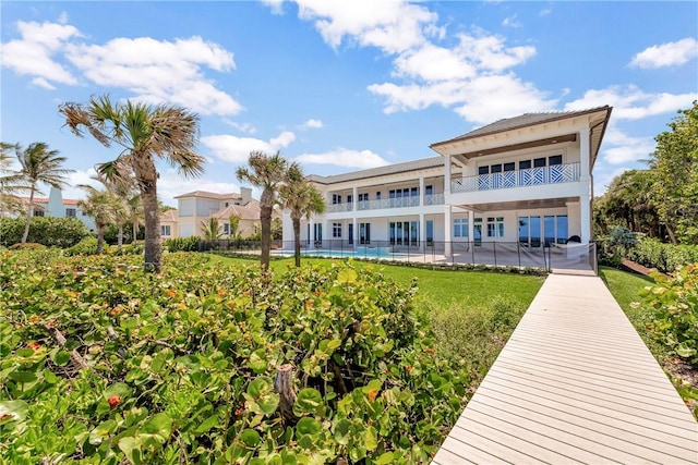 330 N Blue Wave Ln, Vero Beach, FL 32963 - rear view of property with a yard, a balcony, and fence