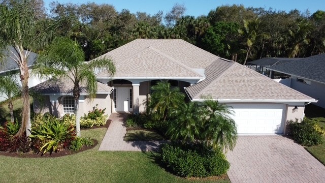 view of front of property featuring a garage and a front lawn