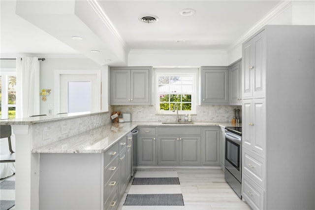 kitchen with a sink, stainless steel appliances, and gray cabinets