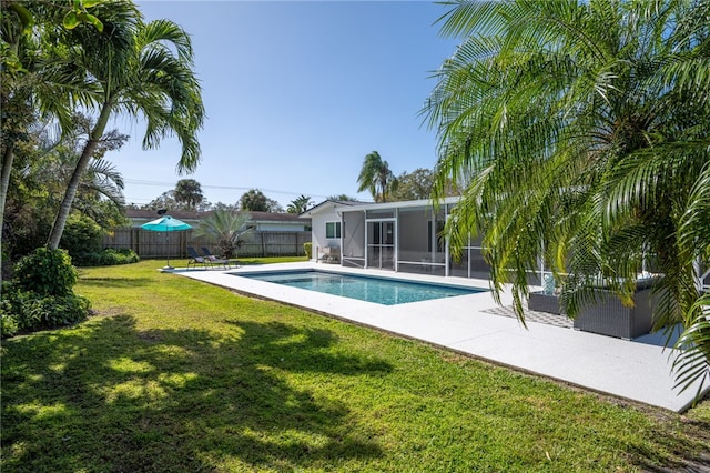 view of swimming pool with a patio, a fenced in pool, a fenced backyard, and a lawn