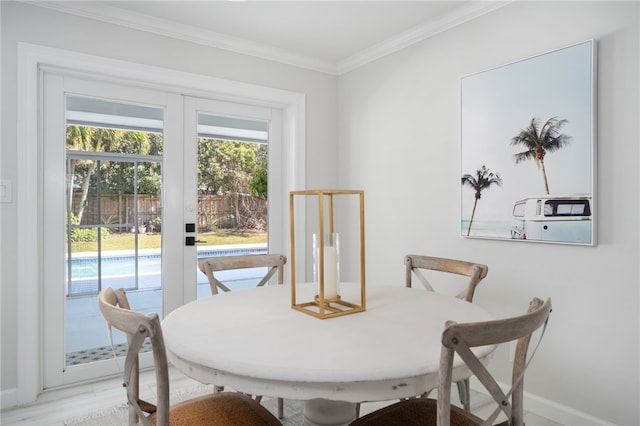 dining room with french doors, crown molding, and baseboards