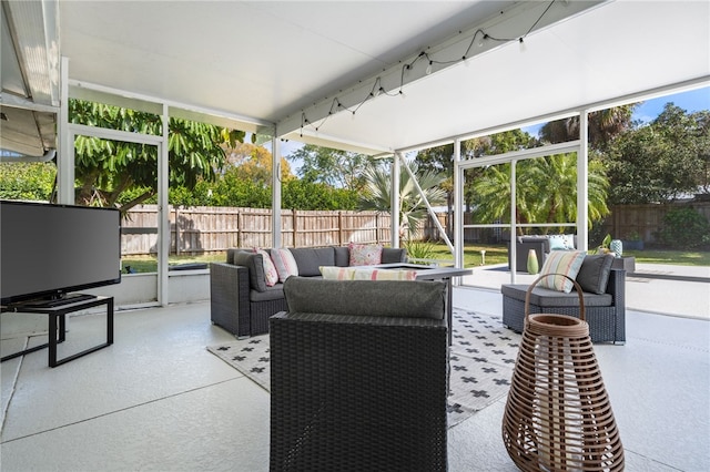 view of patio with a lanai, an outdoor hangout area, and a fenced backyard