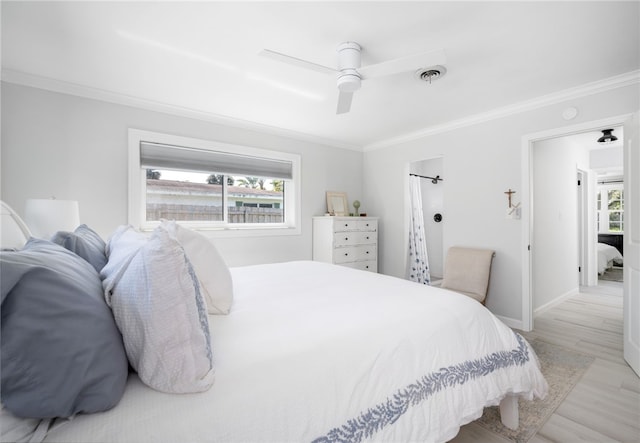 bedroom with crown molding, wood finished floors, and visible vents