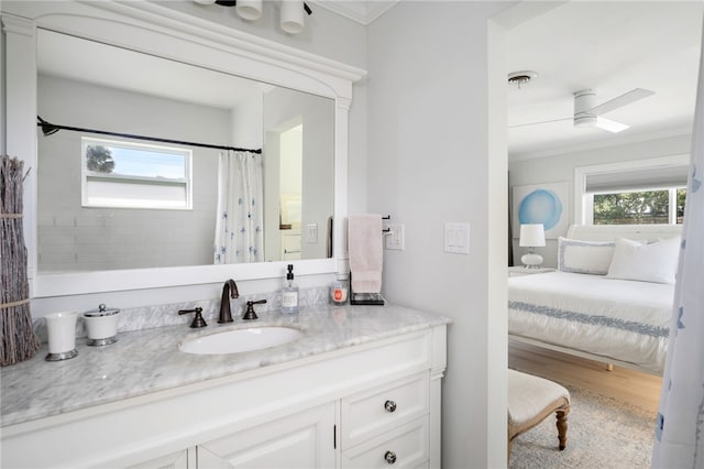 full bathroom featuring plenty of natural light, wood finished floors, visible vents, and ornamental molding