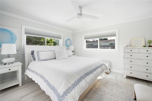 bedroom with baseboards, light wood finished floors, and ornamental molding