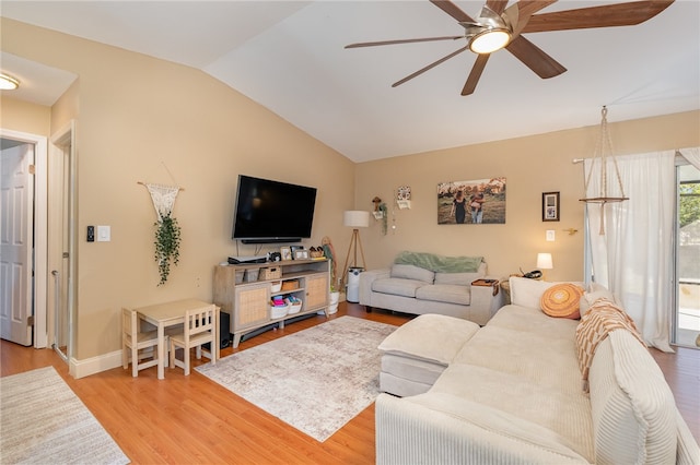 living room featuring ceiling fan, light hardwood / wood-style floors, and vaulted ceiling