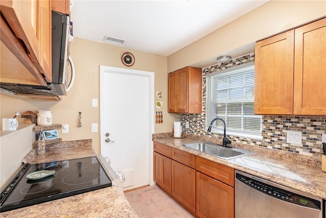 kitchen with stainless steel appliances, tasteful backsplash, and sink