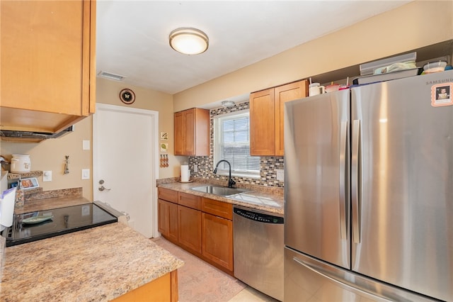 kitchen with decorative backsplash, stainless steel appliances, and sink