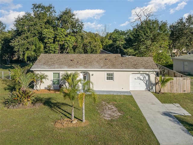 view of front of property with a front yard and a garage