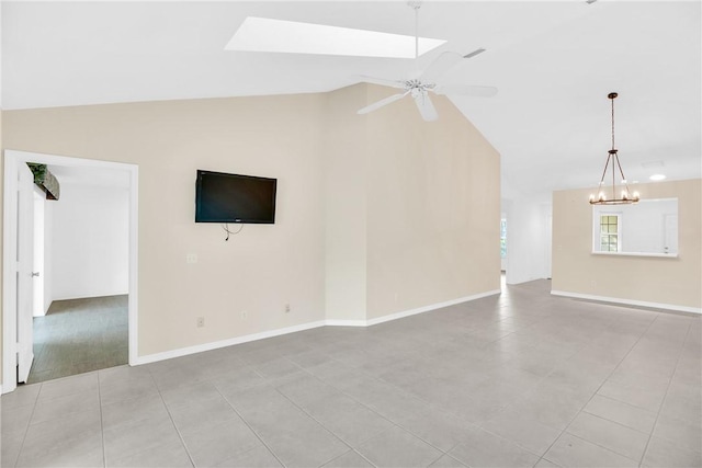 unfurnished living room with lofted ceiling, ceiling fan with notable chandelier, and light tile patterned floors