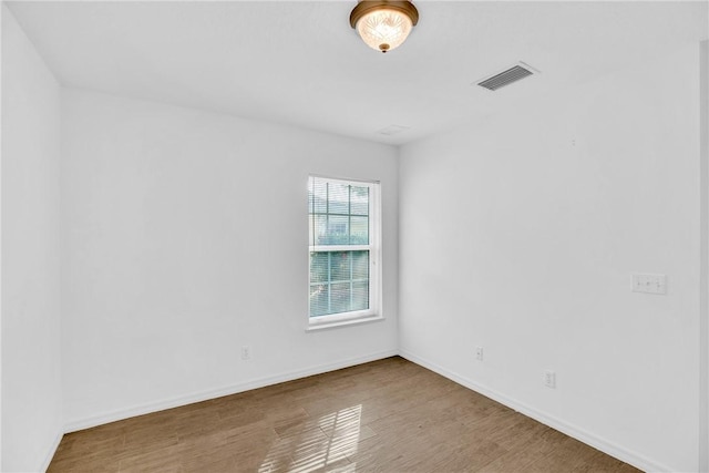 empty room with wood-type flooring