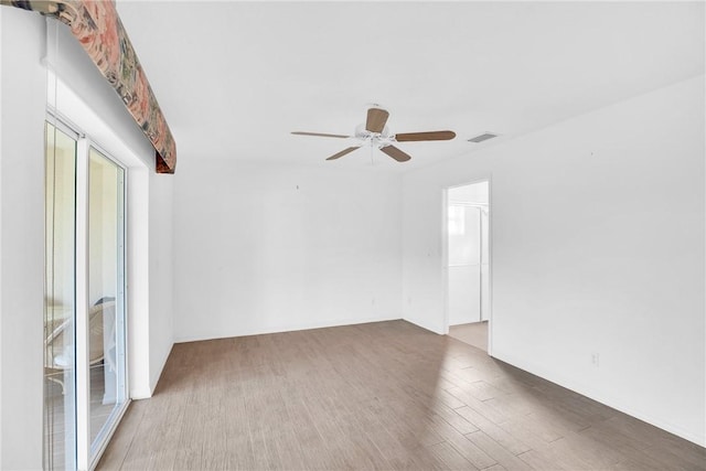 unfurnished room with hardwood / wood-style flooring and ceiling fan